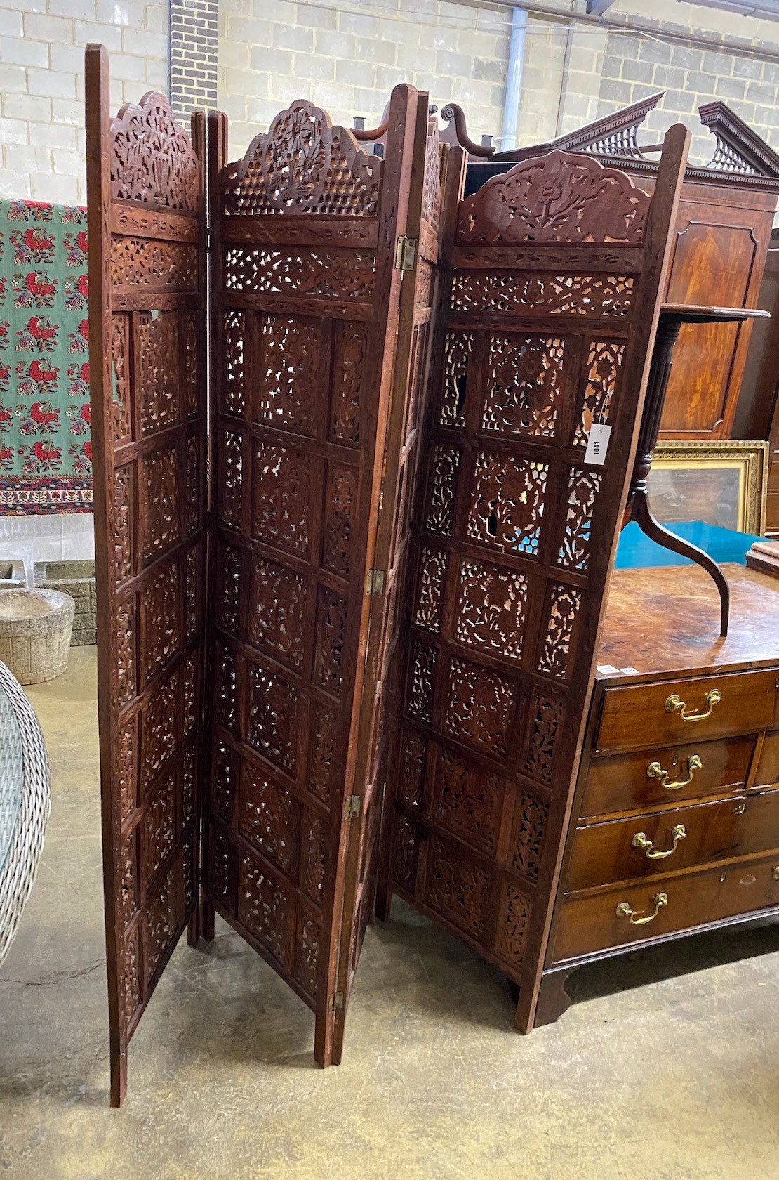 An Indian carved hardwood four fold screen, each panel width 51cm, height 183cm